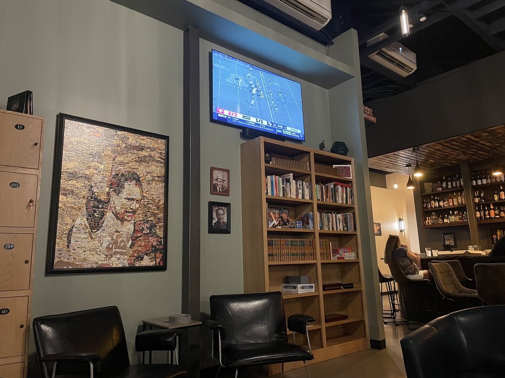 Interior of Wilde Cigars with framed artwork and shelves
