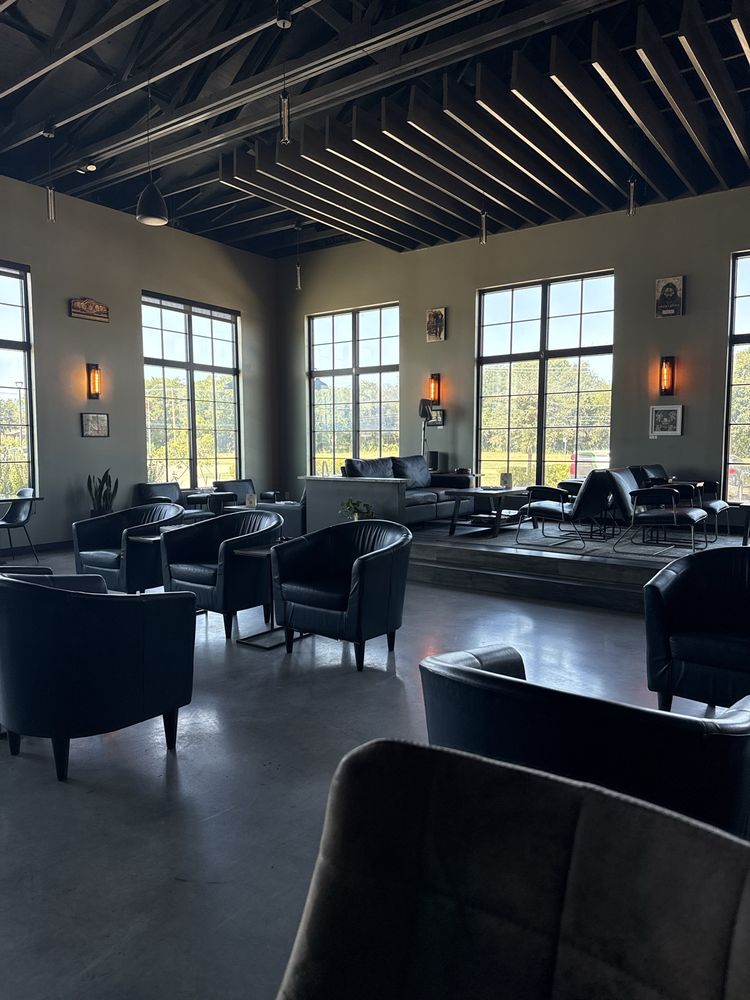 Row of leather chairs and pool table in the Wilde lounge